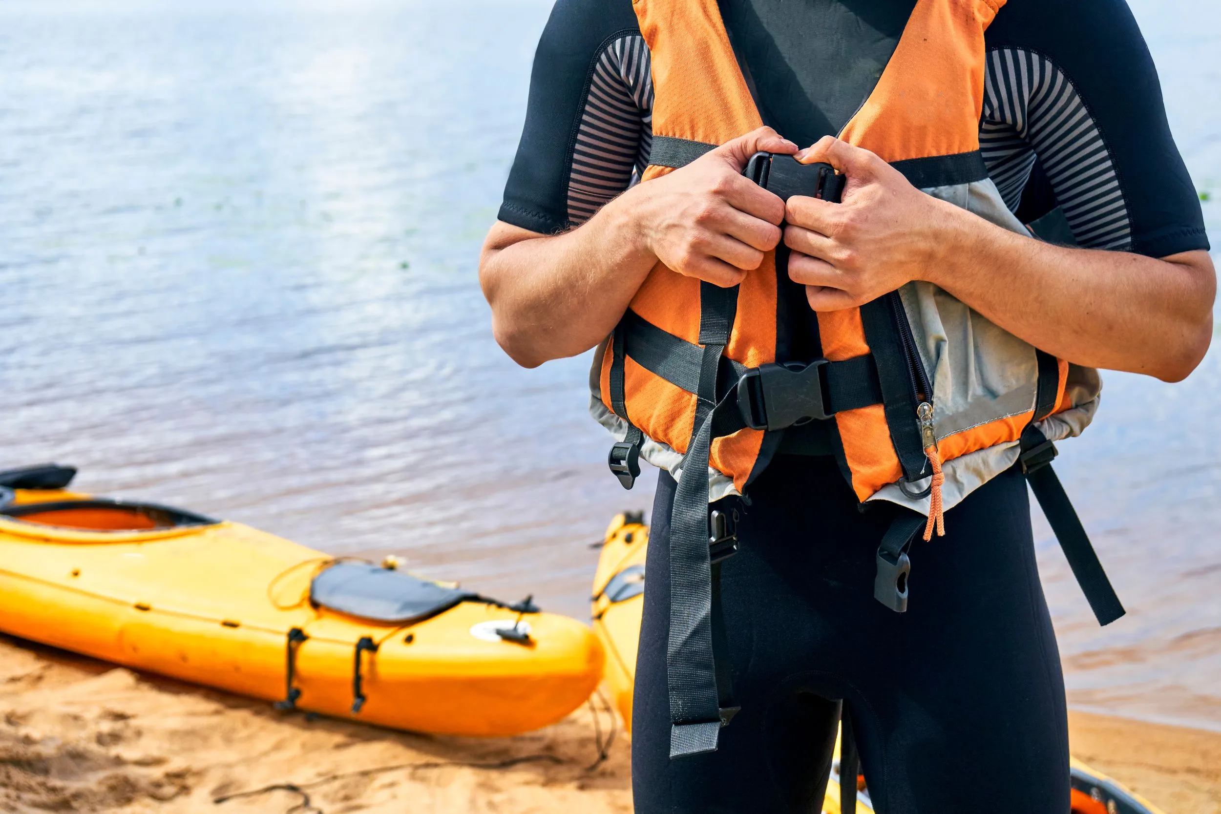 A man buckling up a life jacket