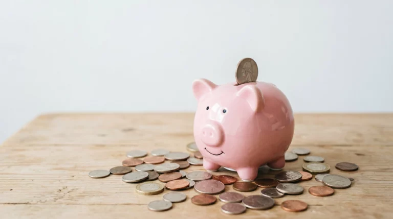 a piggybank with coins surrounding