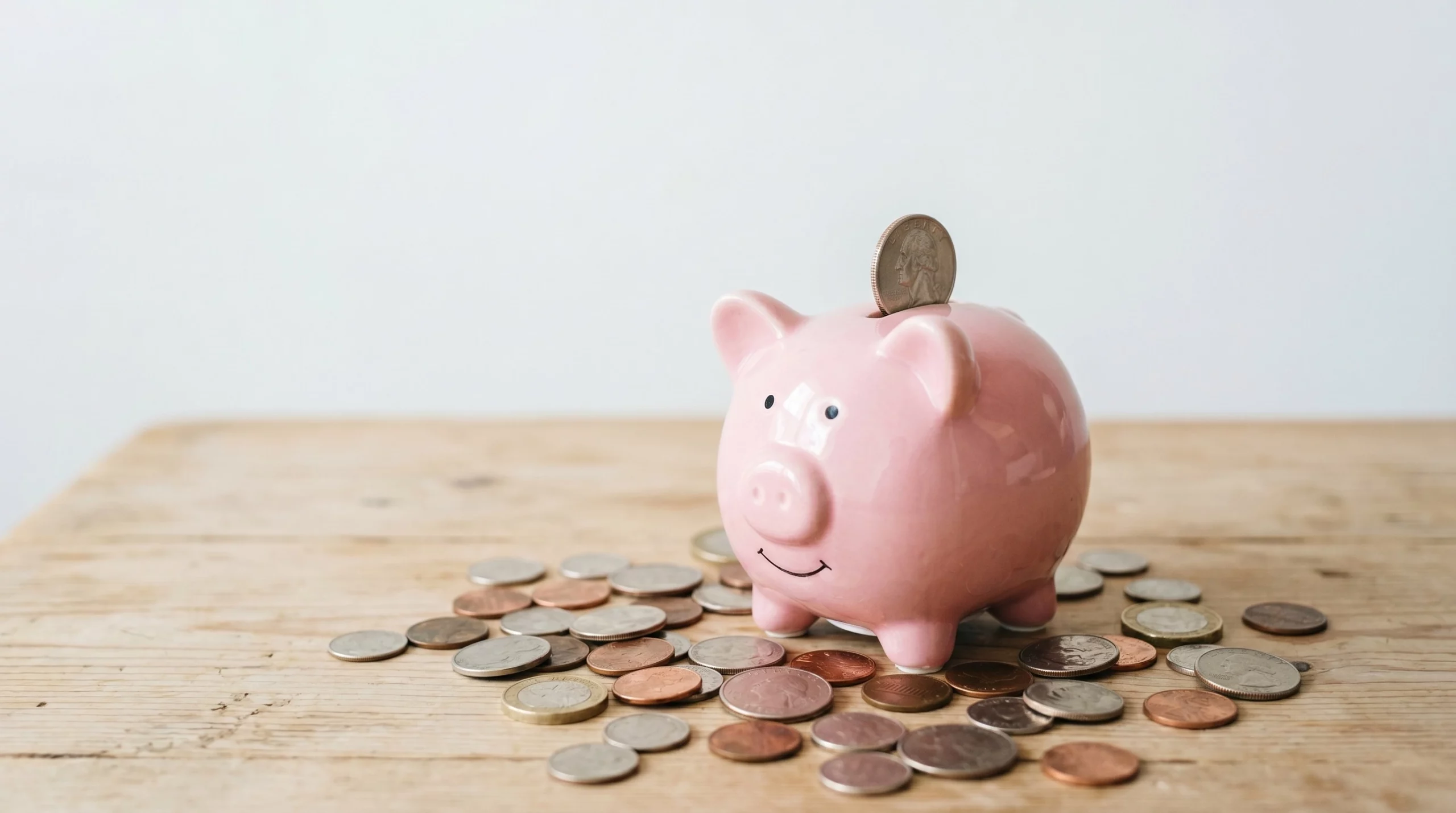 a piggybank with coins surrounding